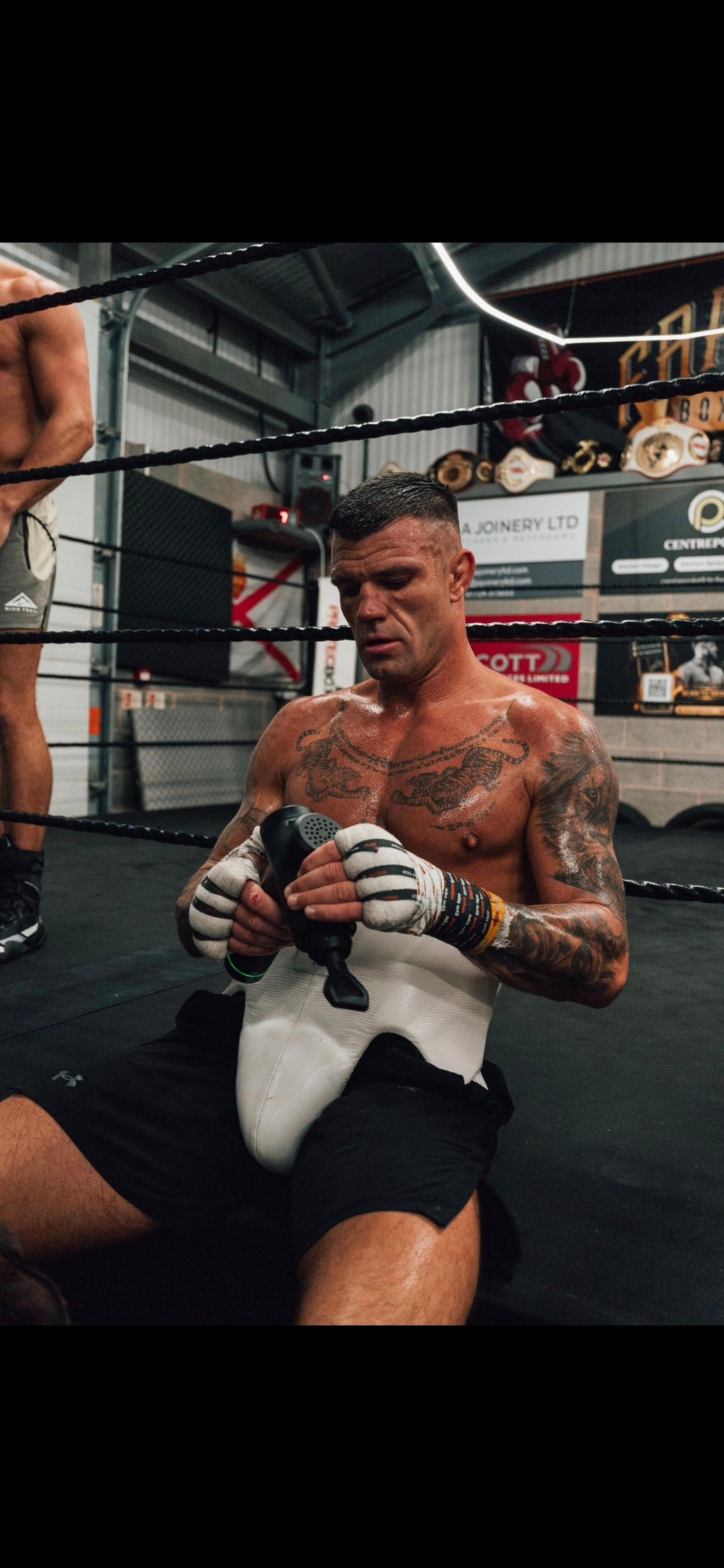 Athlete using massage gun after training