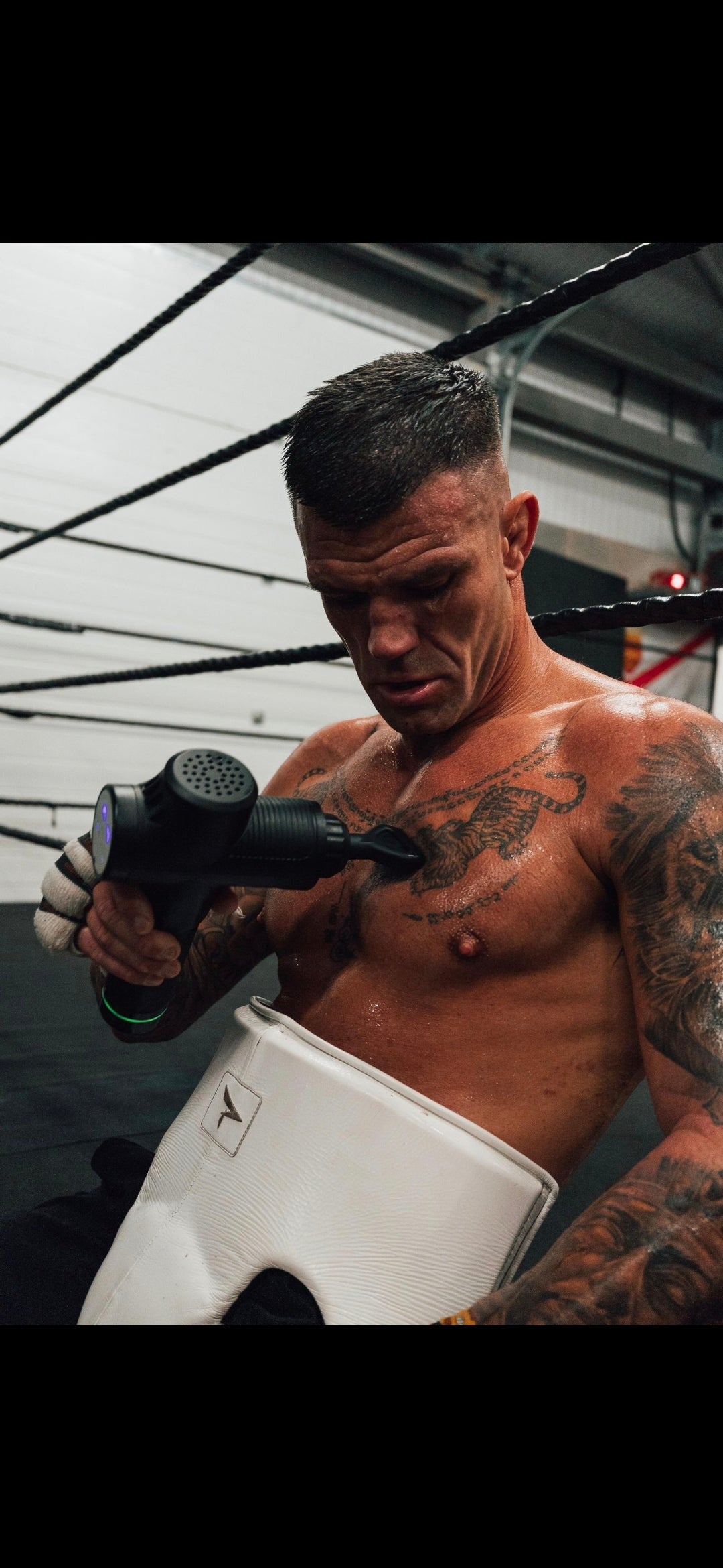 Athlete using massage gun after training